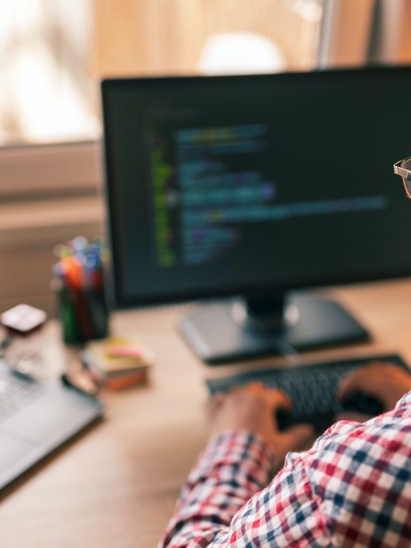 Male programmer working in home office